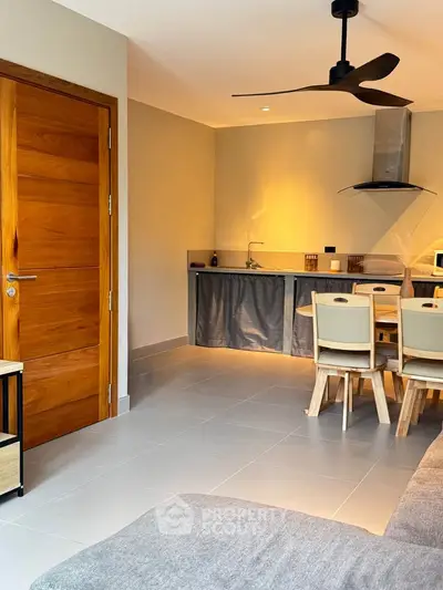 Modern open kitchen and dining area with sleek design and wooden accents.