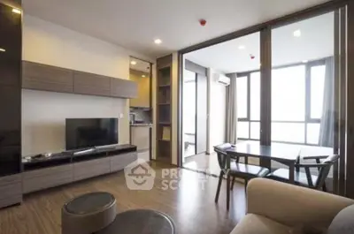 Modern living room with open layout and large windows offering natural light and city views.