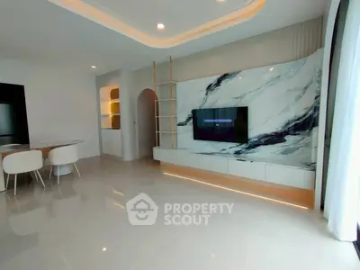 Modern living room with elegant marble TV wall and sleek dining area