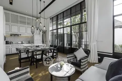 Luxurious open-plan living and dining area with elegant decor and large windows.