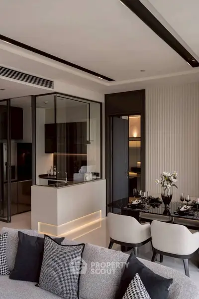 Modern open-plan living room with sleek kitchen and elegant dining area in luxury apartment.