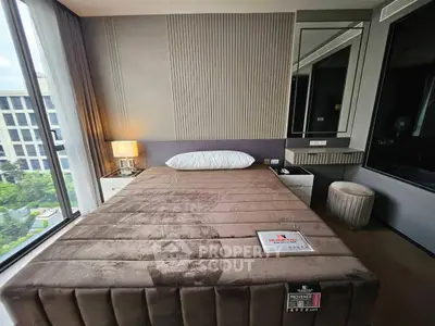 Luxurious bedroom with modern decor and large window offering stunning views.