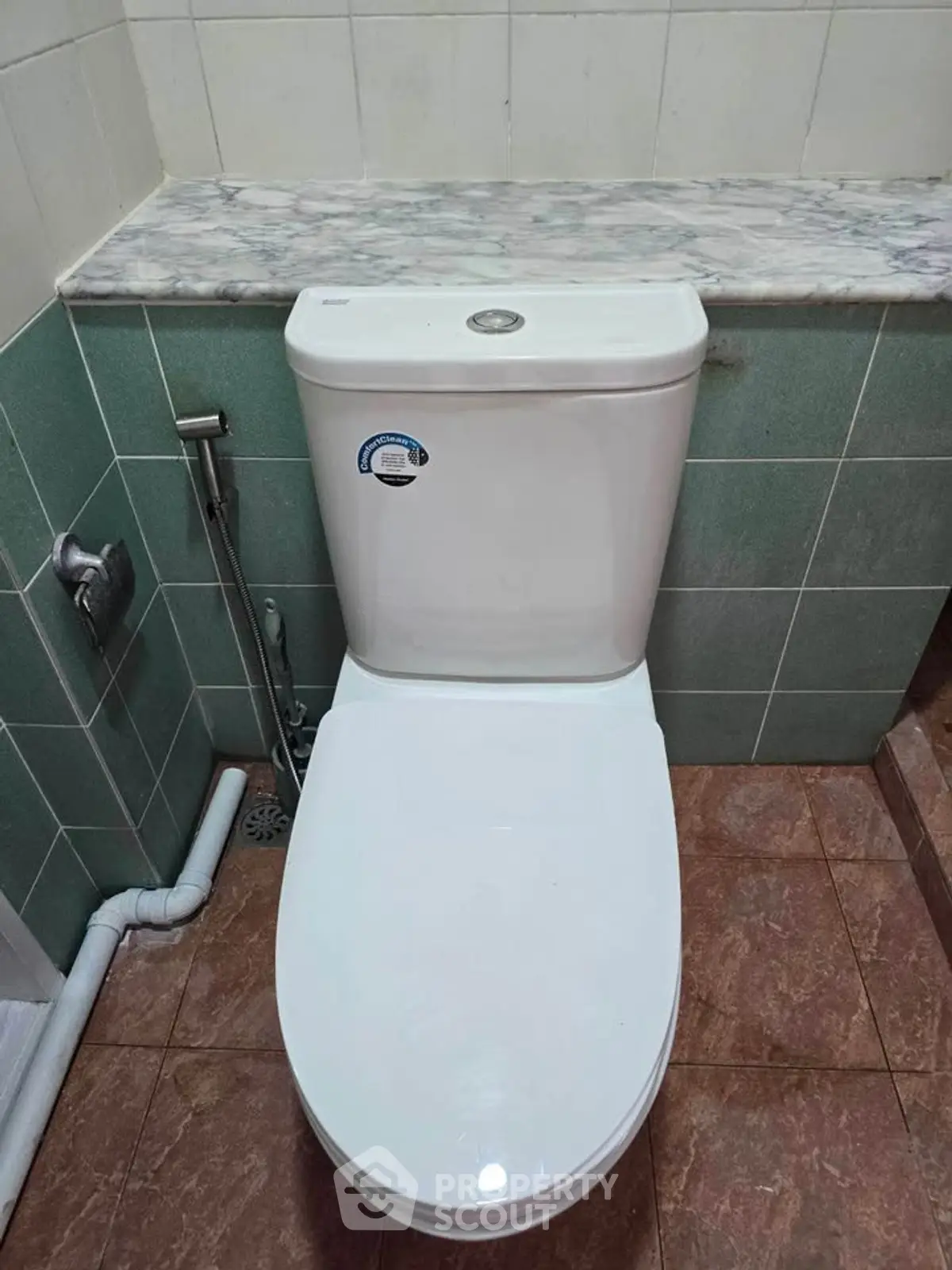 Modern bathroom with sleek toilet and tiled walls