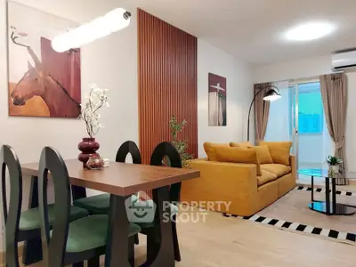 Stylish modern living room with cozy seating and elegant dining area, perfect for urban living.