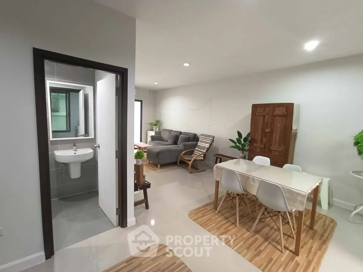 Modern open-plan living and dining area with sleek furniture and neutral tones.