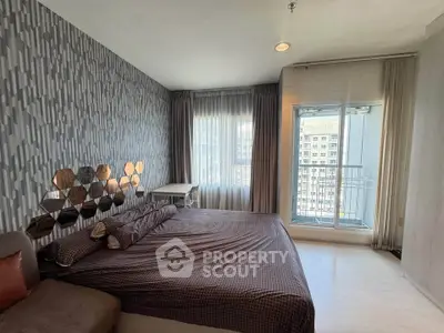 Modern bedroom with stylish decor and balcony view in urban apartment