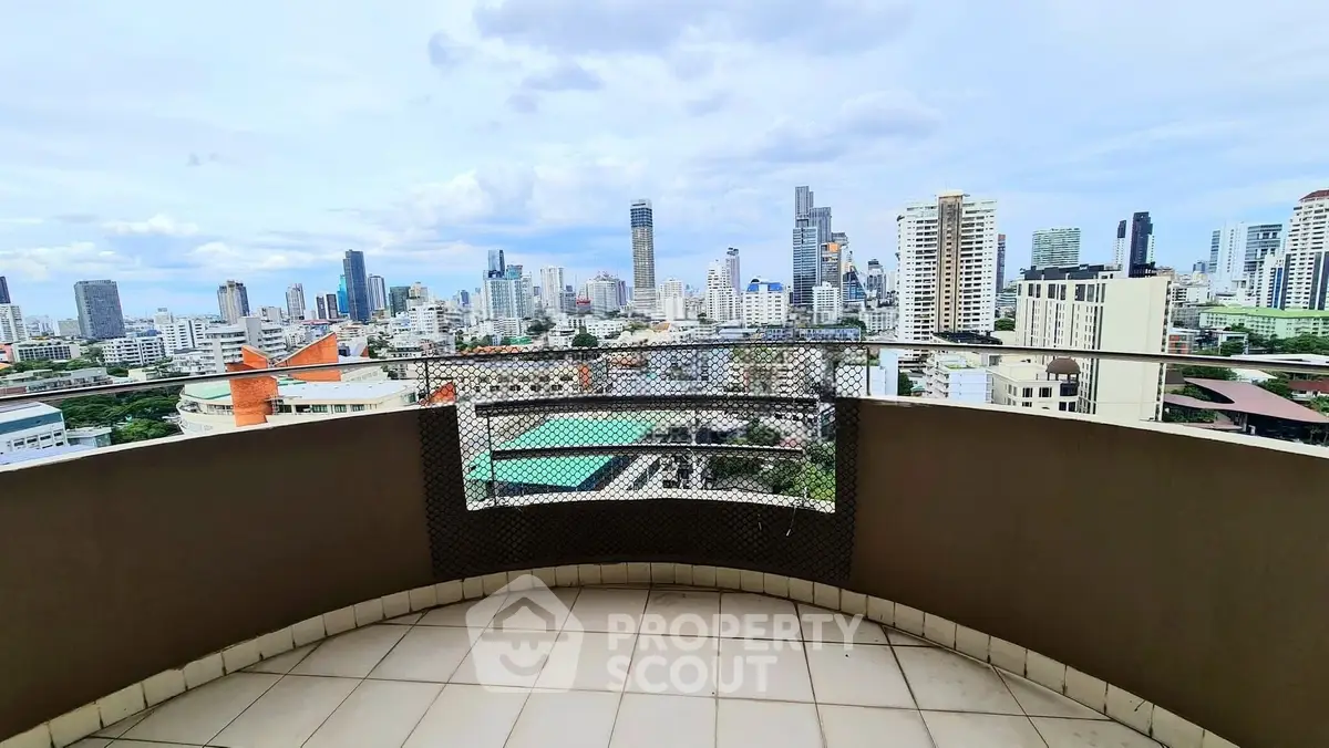 Stunning cityscape view from a spacious balcony in a high-rise apartment, perfect for urban living.