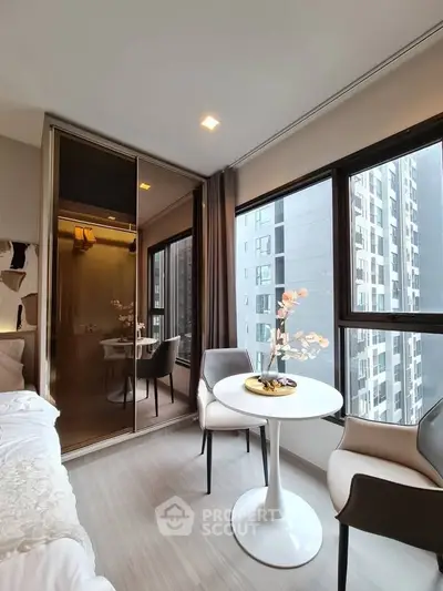 Modern bedroom with large windows and elegant decor in a high-rise apartment.