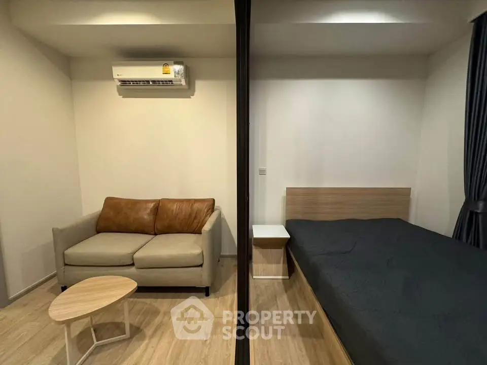 Modern studio apartment with cozy living area and comfortable bed