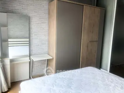 Modern bedroom with stylish wardrobe and vanity set against a chic brick wall.