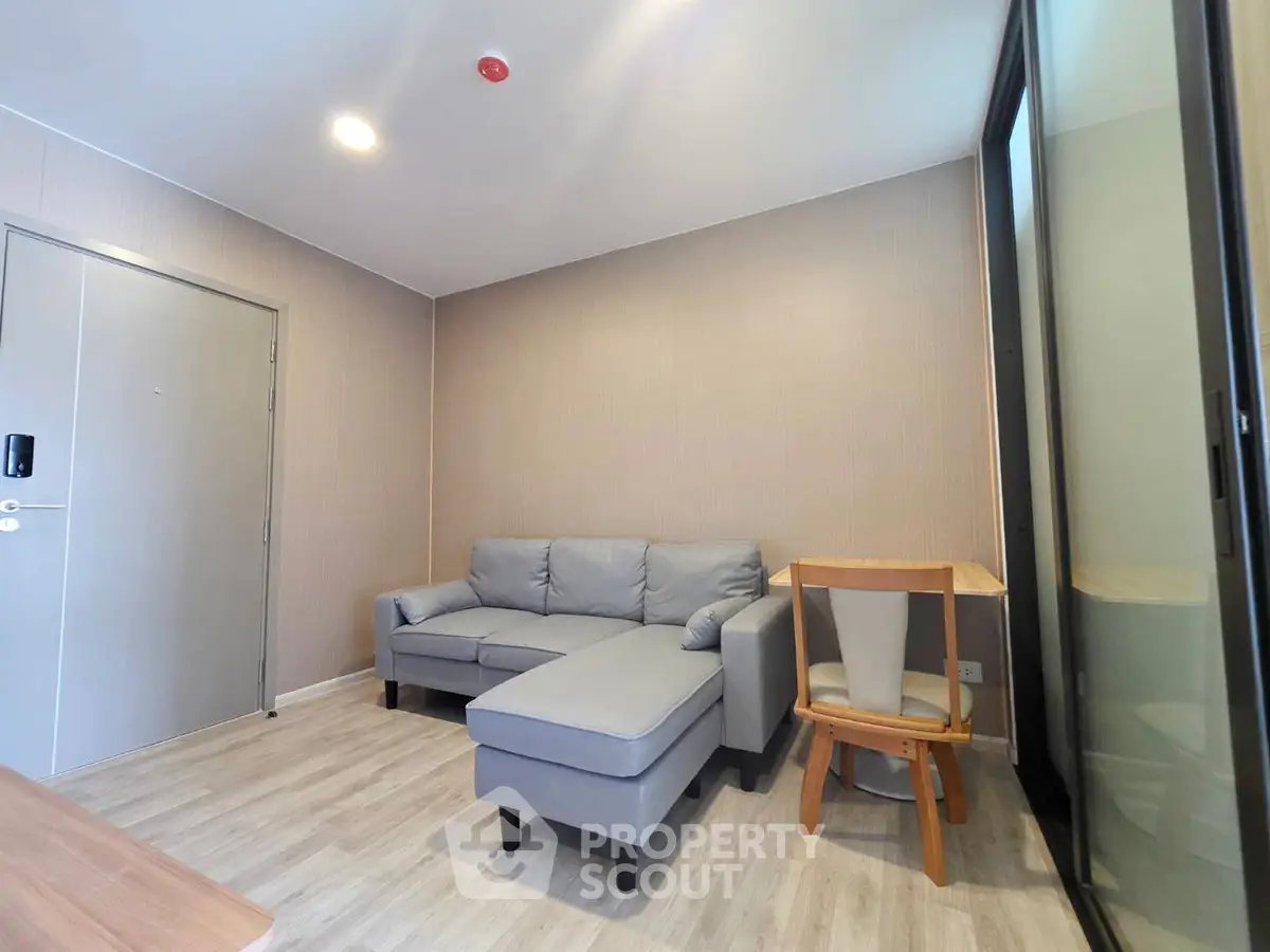 Modern living room with cozy gray sofa and wooden furniture in a stylish apartment.