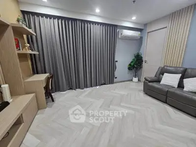 Modern living room with sleek design, featuring a cozy sofa, stylish shelving, and elegant flooring.