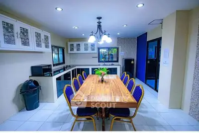 Spacious kitchen with elegant dining table and modern lighting