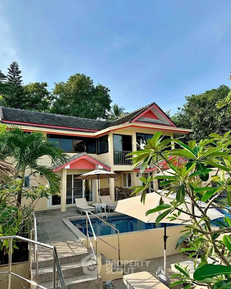 Stunning tropical villa with private pool and lush garden, perfect for luxurious living and relaxation.