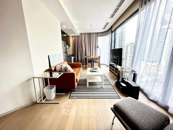 Modern living room with city view, stylish furniture, and floor-to-ceiling windows.