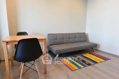 Modern living room with stylish sofa and colorful rug, perfect for cozy gatherings.
