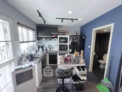 Modern kitchen with sleek appliances and open layout, featuring stylish decor and ample natural light.