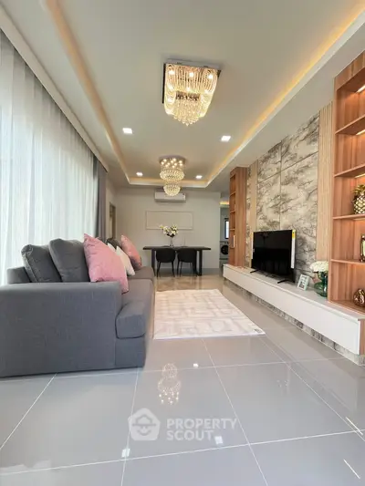 Luxurious modern living room with elegant chandeliers and stylish decor