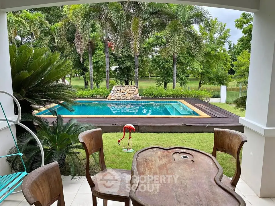 Charming outdoor view with a pool and lush greenery, perfect for relaxation and entertaining.