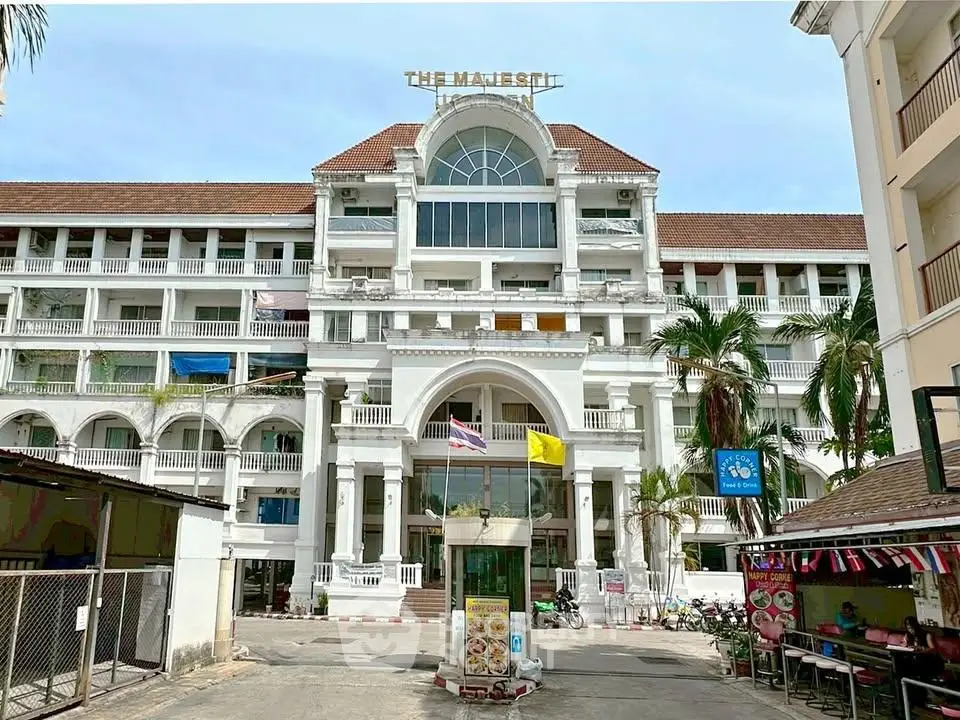 Stunning colonial-style building with grand entrance and tropical surroundings.