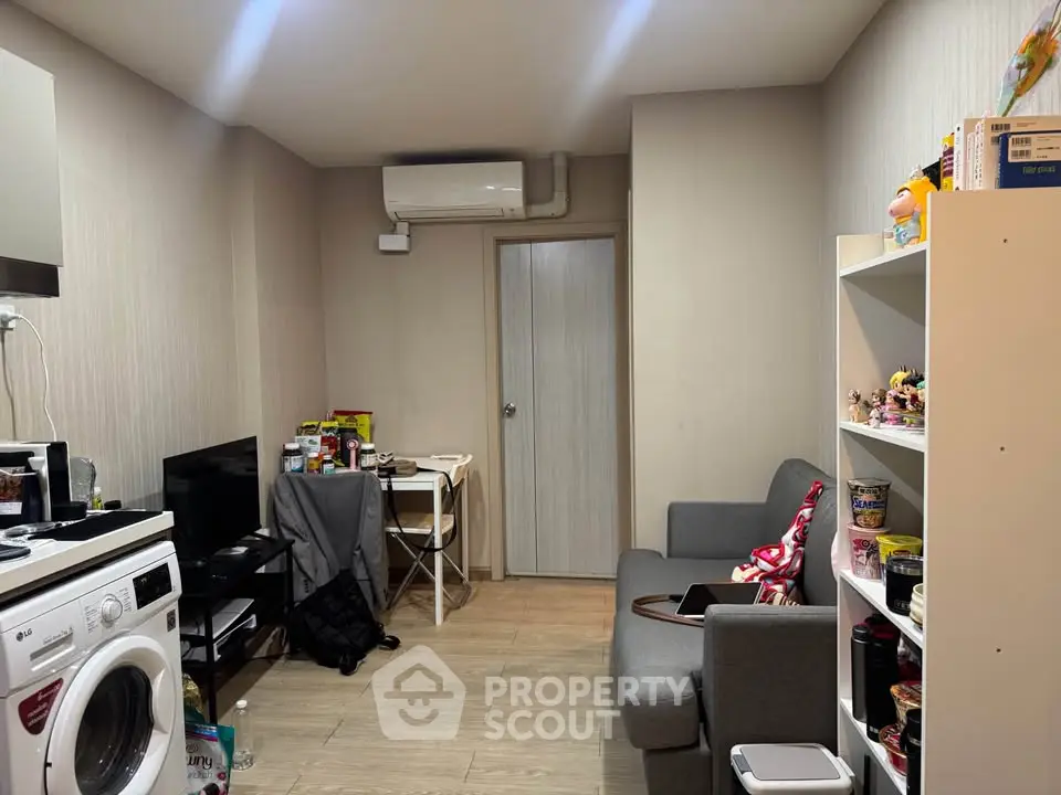 Cozy living room with modern appliances and compact furniture, ideal for urban living.
