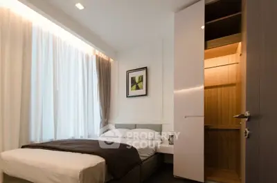 Modern bedroom with cozy bed and open closet in stylish apartment