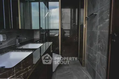 Luxurious modern bathroom with dual sinks and elegant marble finishes.