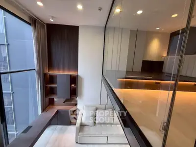 Modern living room with sleek design and large windows offering natural light