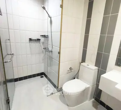 Modern bathroom with glass shower and sleek white fixtures