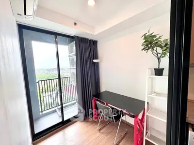 Modern study room with balcony view, featuring sleek desk and chair, ideal for productivity and relaxation.
