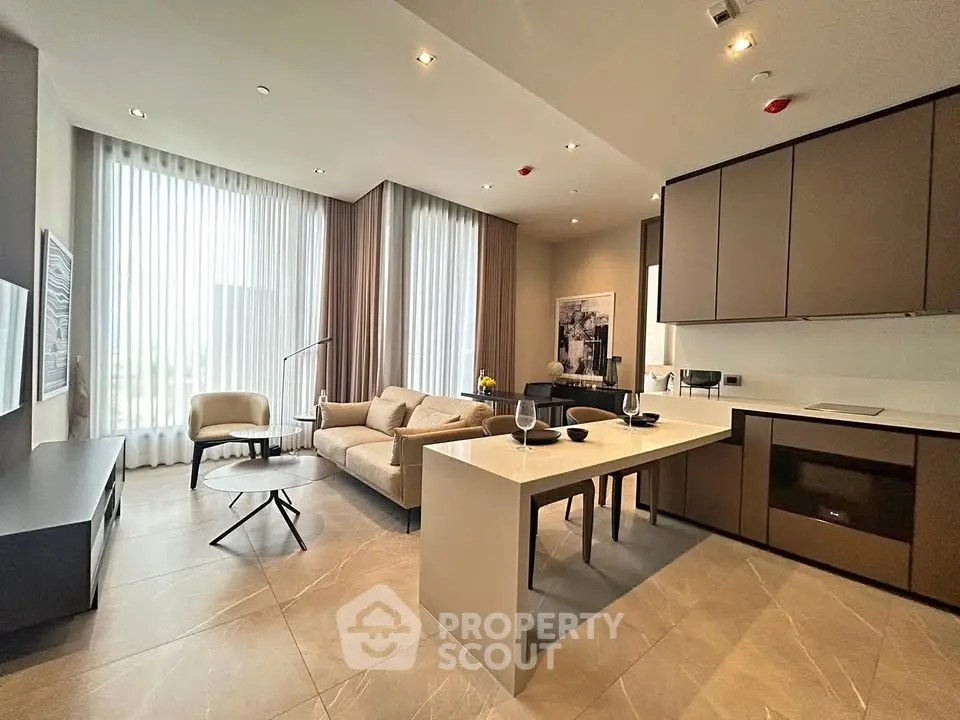 Modern open-plan living room with stylish kitchen and elegant furnishings