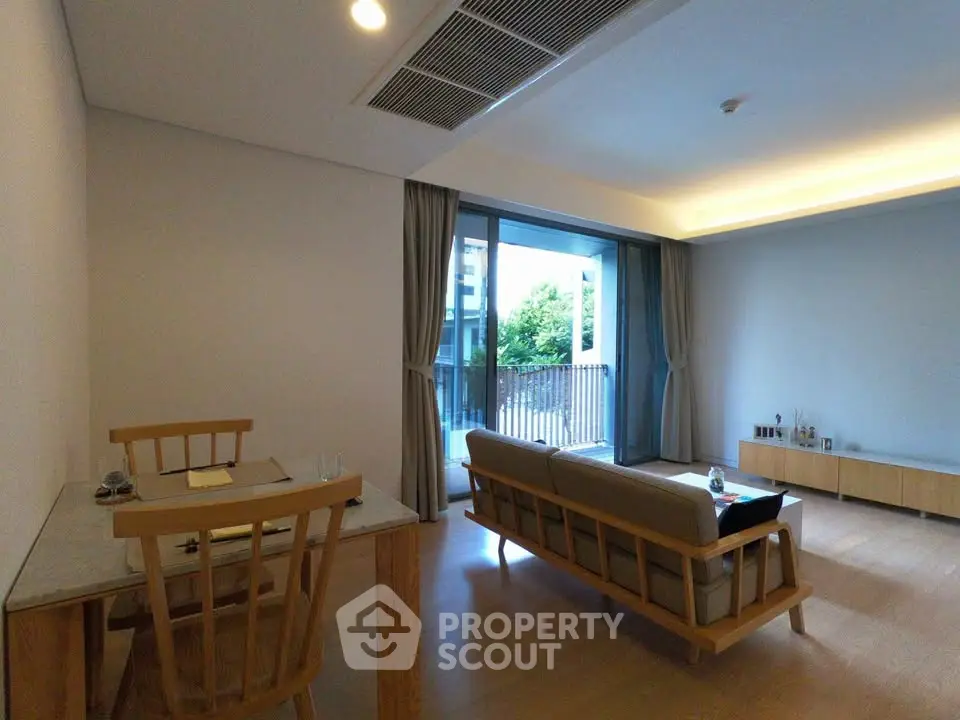Modern living room with wooden furniture and large balcony view