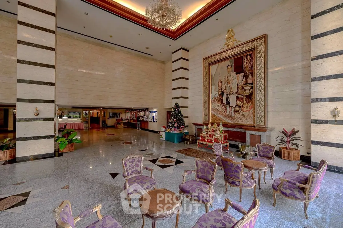 Luxurious hotel lobby with elegant seating and grand artwork, perfect for welcoming guests in style.