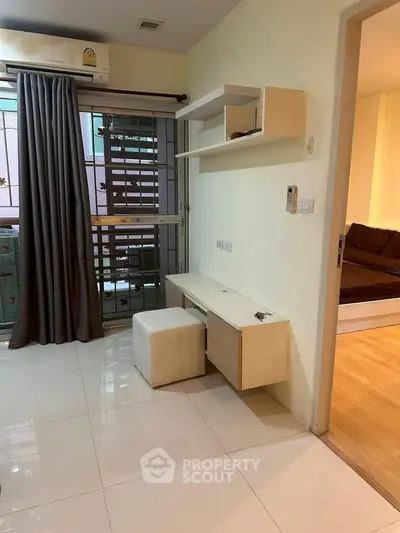 Modern apartment interior with sleek desk and cozy bedroom view