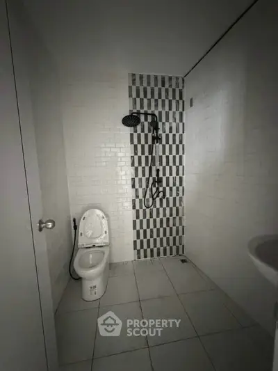 Modern minimalist bathroom with sleek shower and tiled walls