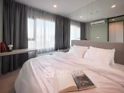 Luxurious bedroom with large windows and elegant decor, perfect for relaxation and comfort.