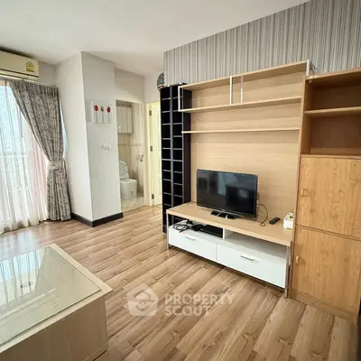 Modern living room with wooden flooring and stylish TV unit
