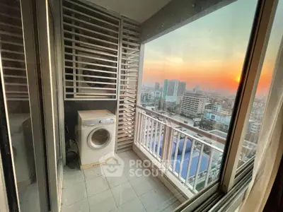 Charming balcony with washing machine and stunning city sunset view