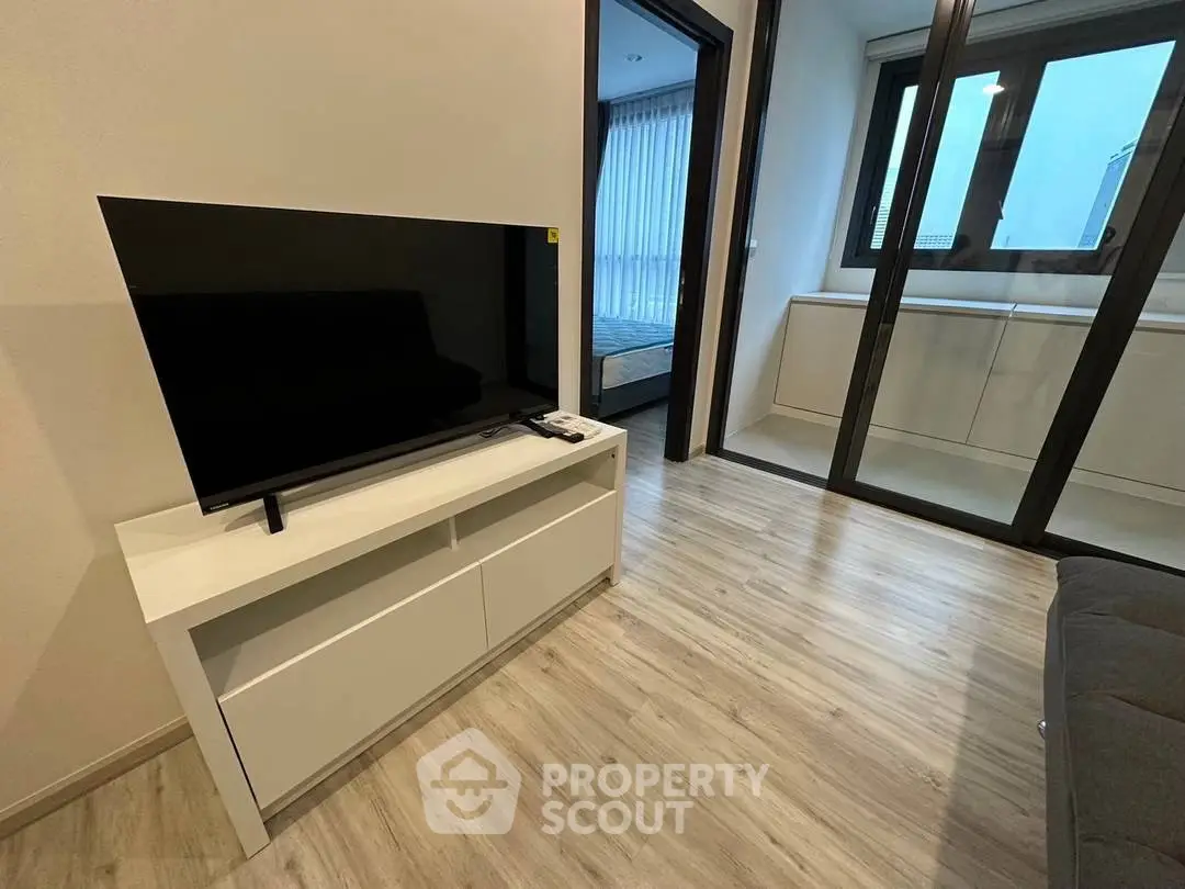 Modern living room with sleek TV stand and large windows