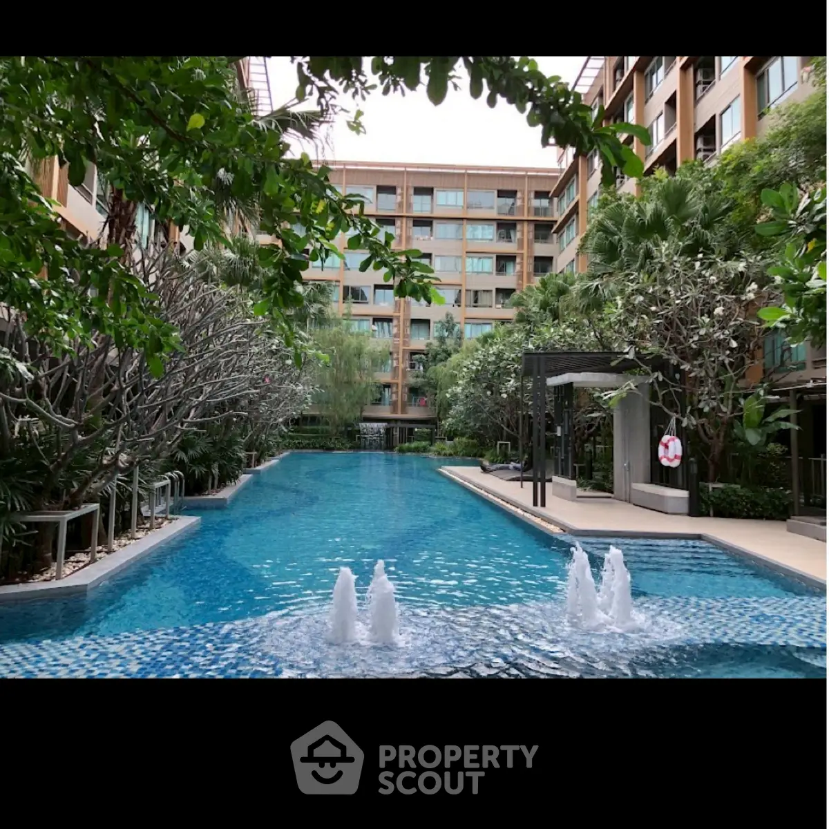 Luxurious residential complex with stunning outdoor pool and lush greenery