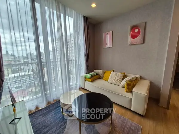 Modern living room with city view, stylish decor, and floor-to-ceiling windows.