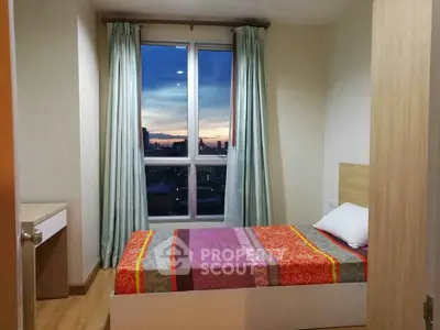 Cozy bedroom with a stunning sunset view from the window, featuring modern decor and vibrant bedding.