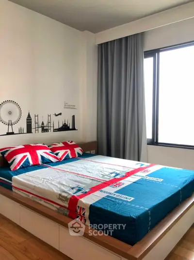 Modern bedroom with stylish decor and large window for natural light.