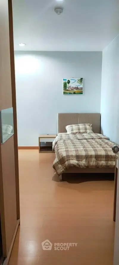 Cozy bedroom with modern decor and wooden flooring