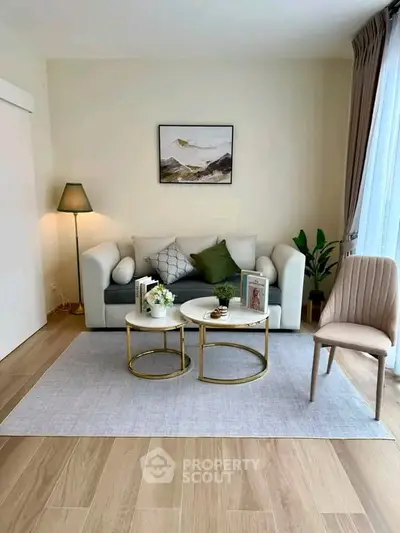 Stylish living room with modern decor, cozy sofa, and elegant coffee tables in a bright apartment.