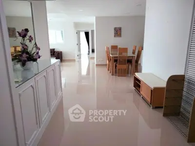 Spacious open-plan living and dining area with modern decor and natural light.