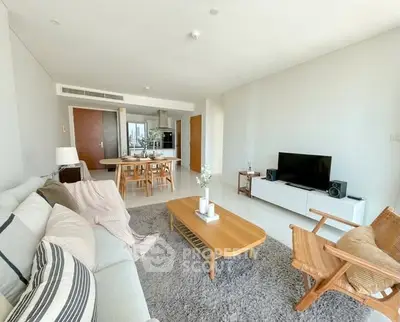Spacious modern living room with stylish furniture and open layout in a bright apartment.