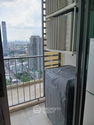 High-rise balcony with city view and laundry area, perfect for urban living.