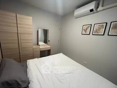 Cozy bedroom with modern decor and air conditioning in a stylish apartment.