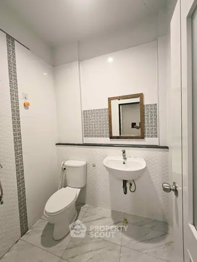 Modern bathroom with sleek white tiles and elegant fixtures
